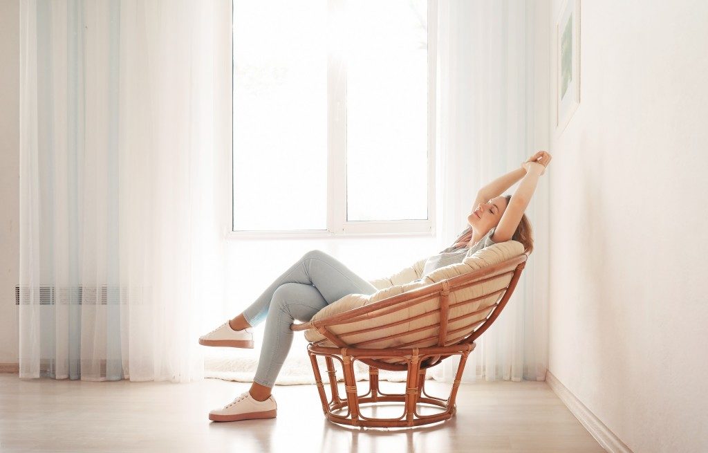woman sitting on a comfy chair at home